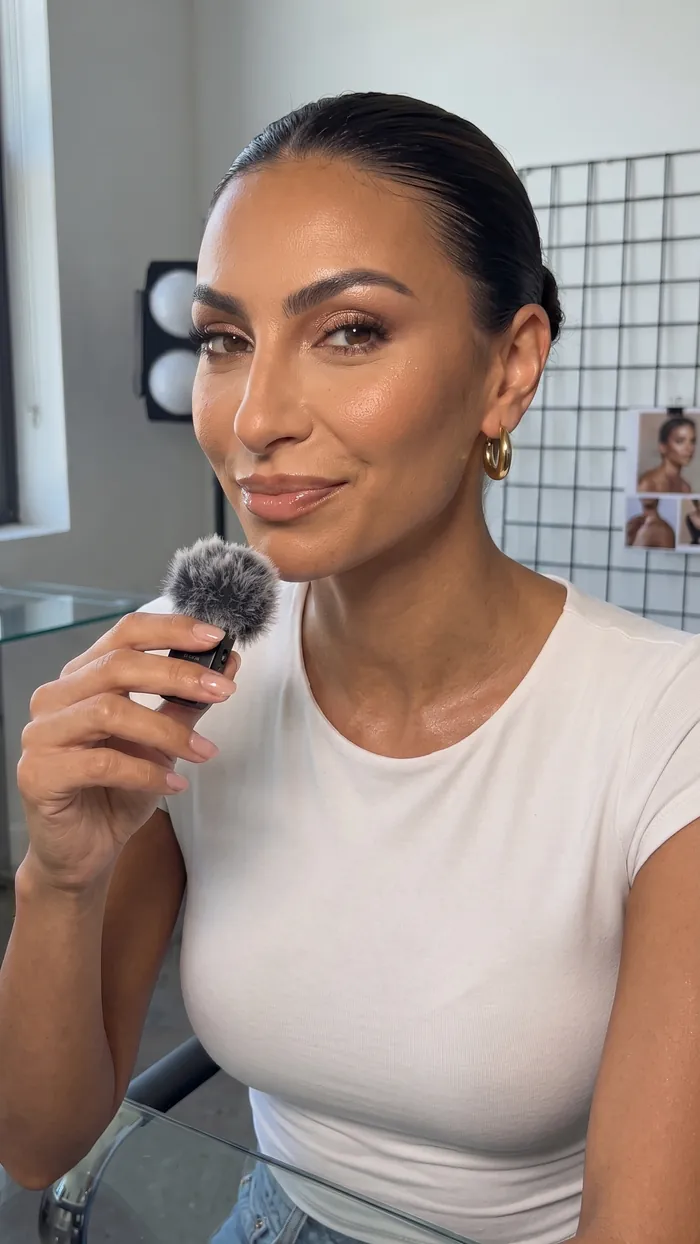 Creator Imane Oubou filming a piece to camera with a handheld mic